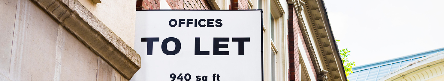 Building with an offices to let board attached to its wall